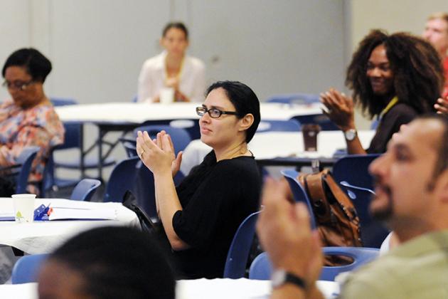 Celines Pomales, a new ESL teacher at PS 148Q, applauds a speaker during the New