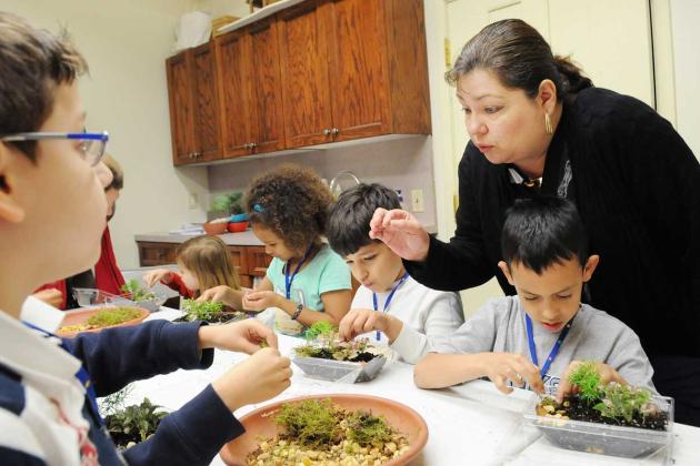 Gently, gently, teacher Nancy Ioannou advises her gardeners.