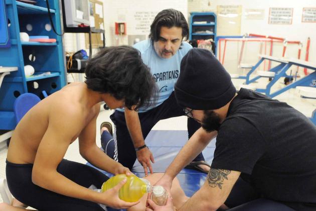 Teacher gives instruction on how to use a bag valve mask