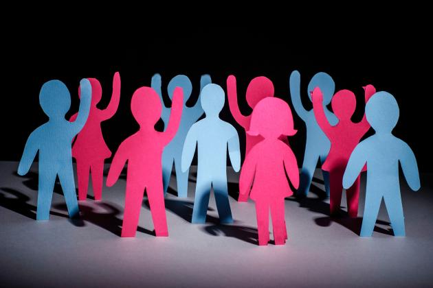 An image of people made of paper with their hands up