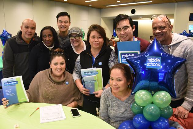 Group of UFT members holding middle school brochure