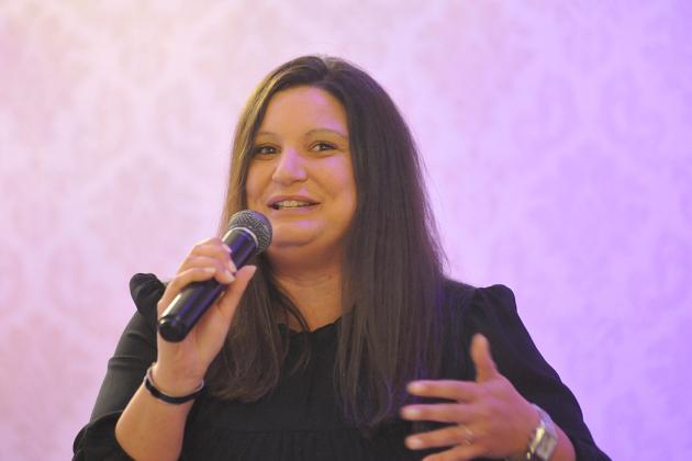 A women speaks into a microphone