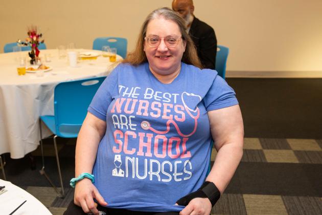 A woman shows off her shirt 