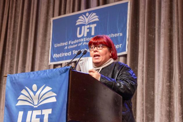 A woman speaks at the podium
