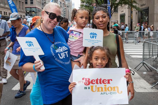 A woman marches with her three daughters