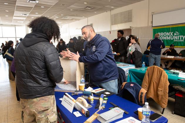 A student gets information at a table during the UFT's Future in Focus fair. 