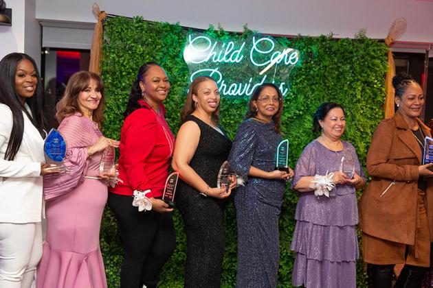 A group of award winners pose for a photo 