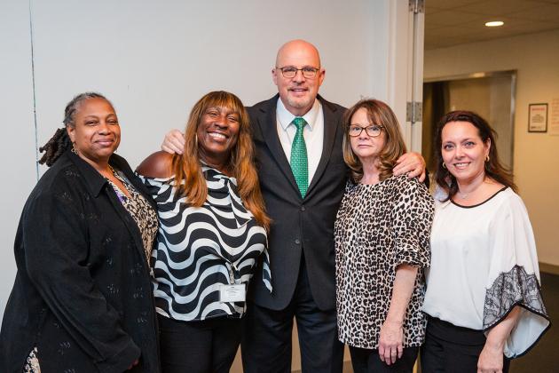 School nurses and UFT President Michael Mulgrew take a group photo at the 2024 UFT School Nurses Appreciation Dinner on May 8, 2024.