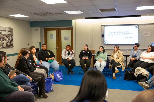 A group of attendees sit in a circle during a self-regulation workshop.