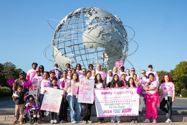 Hillcrest High School members pose for a group photo in front of the Unisphere in Flushing Meadows Corona Park at the Making Strides Walk on Oct. 20, 2024