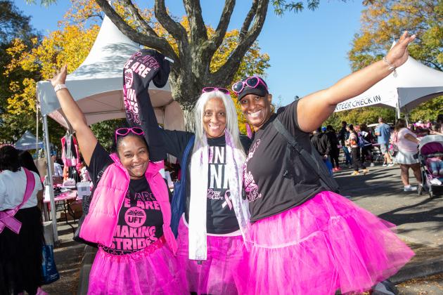 Three UFT members wearing black and pink shirts pose for a photo at a Making Strides Walk in Queens on Oct. 20, 2024