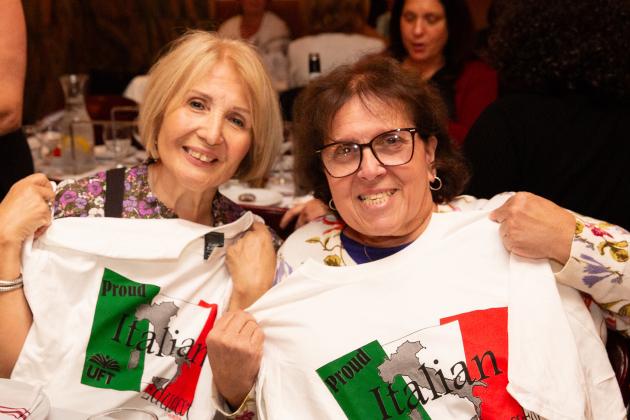 Two women in attendance at a UFT Italian Heritage Committee dinner hold up their 