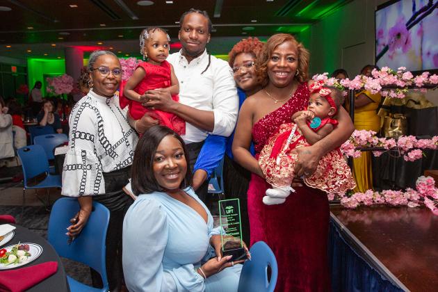 Nickashia M. London (seated) takes a photo with her guests at the 2024 Provider Appreciation Awards Ceremony at UFT Headquarters on May 10, 2024. 