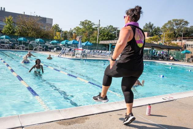 A teacher leads an aqua yoga class during a day of wellness for educators on September 14, 2024. 