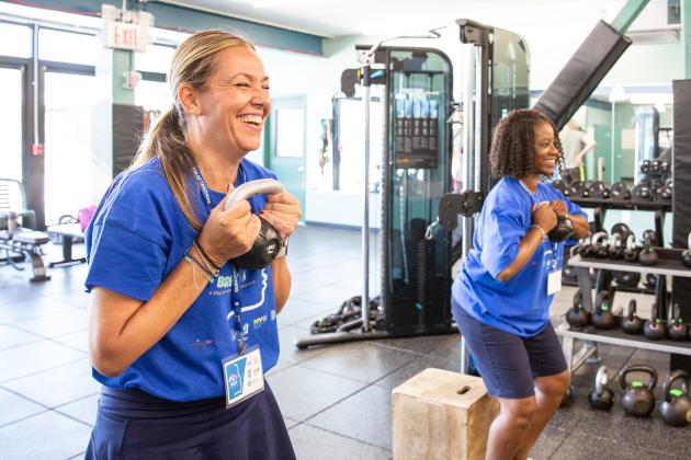 Two teachers take part in a strength training workshop during a day of wellness for educators on September 14, 2024