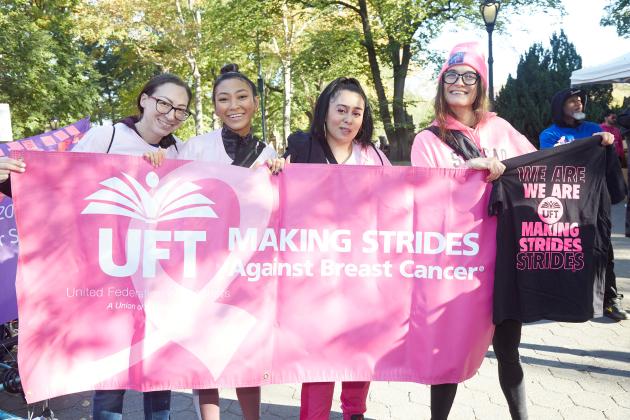 Central Park East II members hold up a banner at the Making Strides Walk in Manhattan on Oct. 20, 2024.