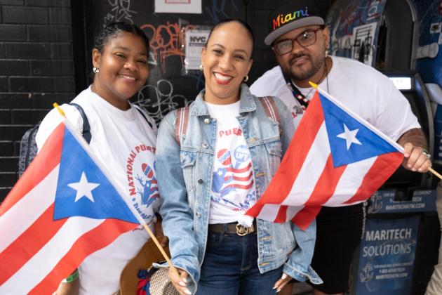 Two women and a man pose for a photo
