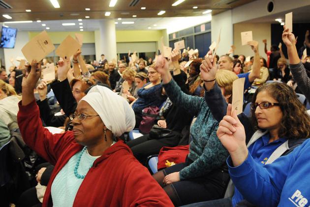 UFT Members raise ballots in hand