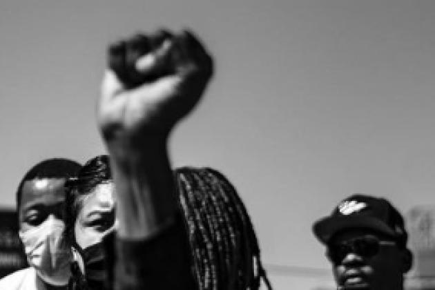 A fist in the air at a group protest