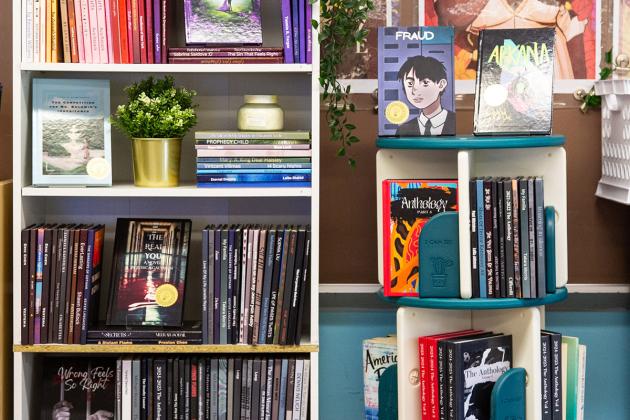 Student novels displayed on bookcase