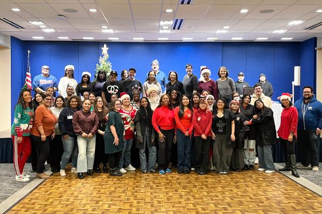 Volunteers take a group photo at the UFT/Coalition for the Homeless holiday toy drive and celebration on Dec. 7, 2024. 