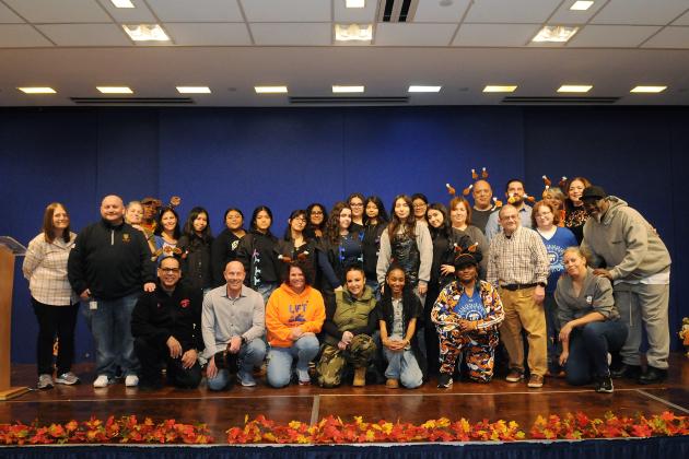 UFT members and staff who volunteered to supervise craft tables and distribute coats — including Vice President for Middle Schools Richard Mantell, kneeling, second from left — get together for a group shot.