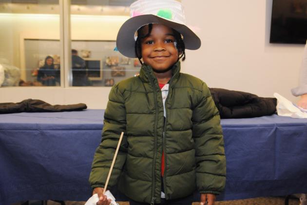 A student models the hat they decorated at a craft station and their brand-new coat at the UFT Middle School Division’s annual Thanksgiving Luncheon on Nov. 23, 2024. 