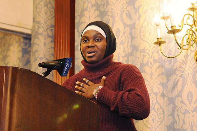 A female student speaks at the podium after receiving an award. 