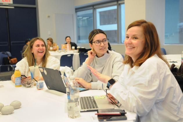 Women at a table have a group discussion at a MindUp event at UFT headquarters