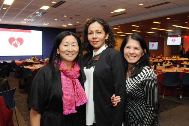 Three women at a nurses celebration pose for a photo