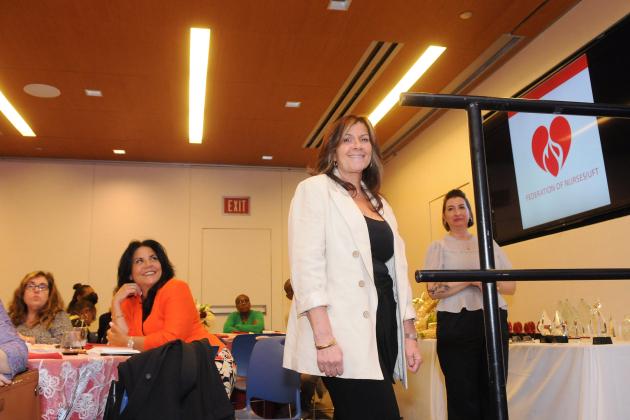 Maria Scudiero, a medical/surgical nurse at NYU Langone–Brooklyn, walks up to the stage at the 2024 Nurses Recognition Dinner at UFT Headquarters on May 9, 2024