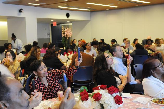 The crowd records an honoree speaking at a nurse celebration