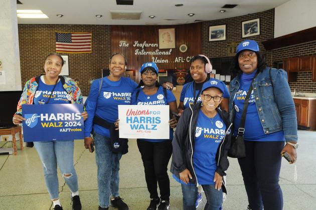 Paraprofessionals take a group photo at the union hall in Philadelphia before spending the morning door-knocking for Kamala Harris and Tim Walz.