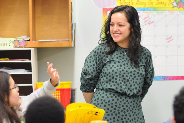 Teacher with student raising hand