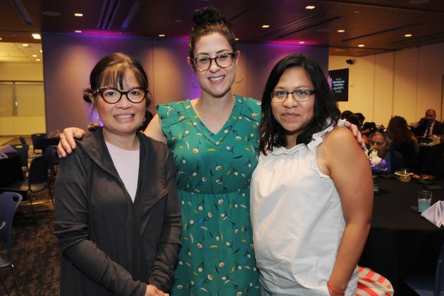 Three women pose for a photo at an awards ceremony