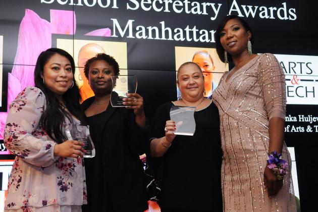 Three award winners pose for a photo with their chapter leader on the right.