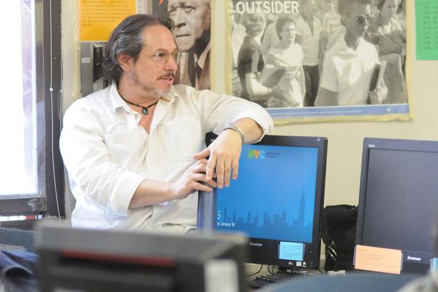 Teacher looking on while resting on a computer screen