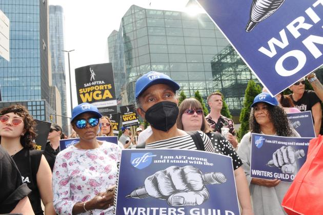 UFT members hold signs in support of the writers strike 