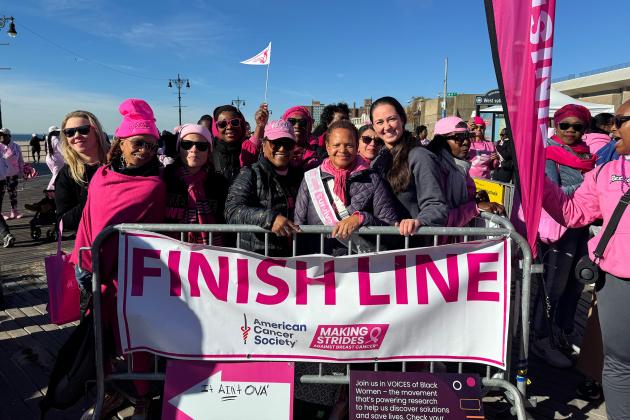 Members from PS 46 in Brooklyn gather at the finish line on the Coney Island boardwalk at a breast cancer awareness walk on Oct. 27