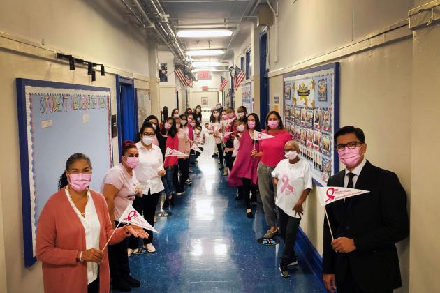 Members of PS 115M line down the hall for a socially distant photo. 