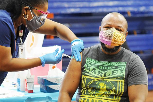 Teacher Garfield Reid of JHS 123 in the Bronx gets vaccinated