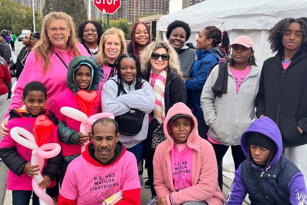 A group of marchers pose for a photo.