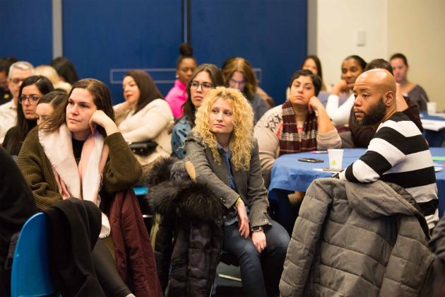 Attendees listen to a presentation