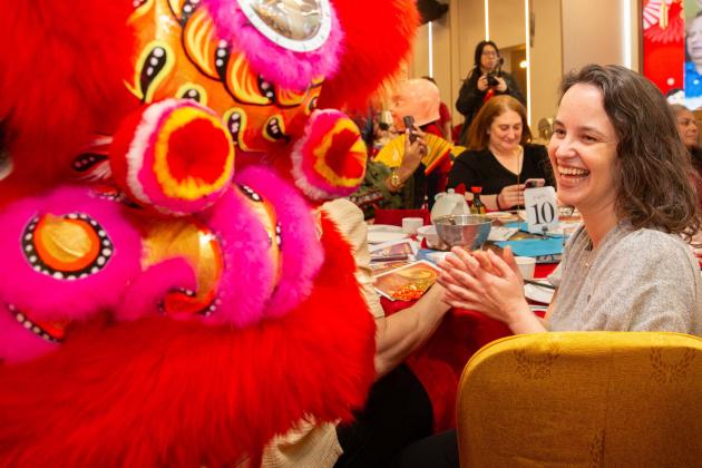 Maggie Joyce, the chapter leader at PS 35 in the Bronx, gets into the spirit of the traditional lion dance at the banquet.