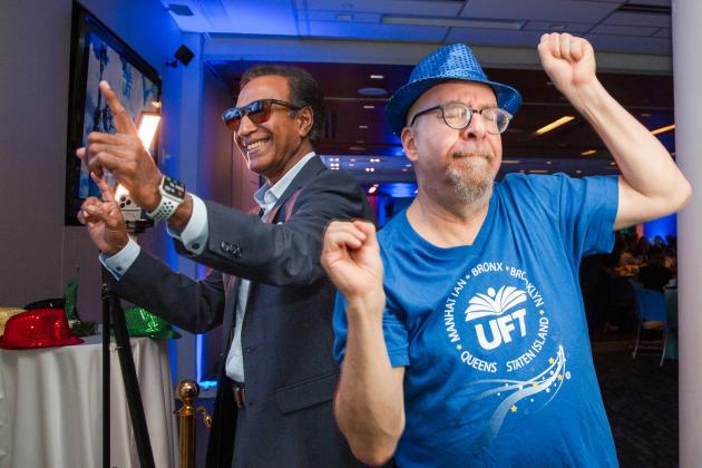 Two UFT members at the 2026 Academic High Schools Awards take a celebratory dance break. 
