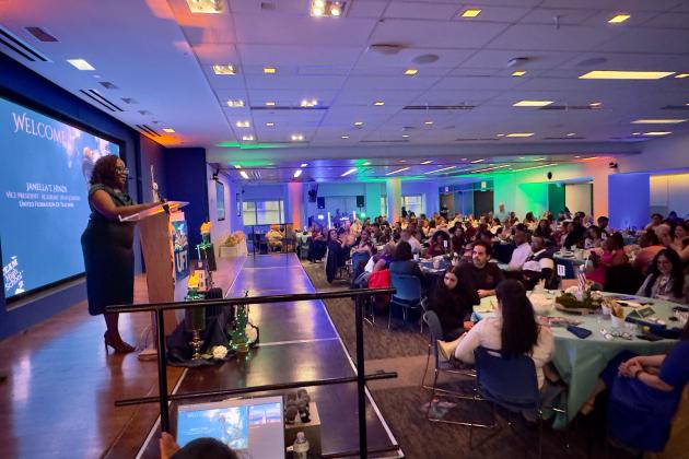 UFT Vice President for Academic High Schools Janella Hinds welcomes a crowd of some 300 people to the 2026 UFT Academic High School Awards. 