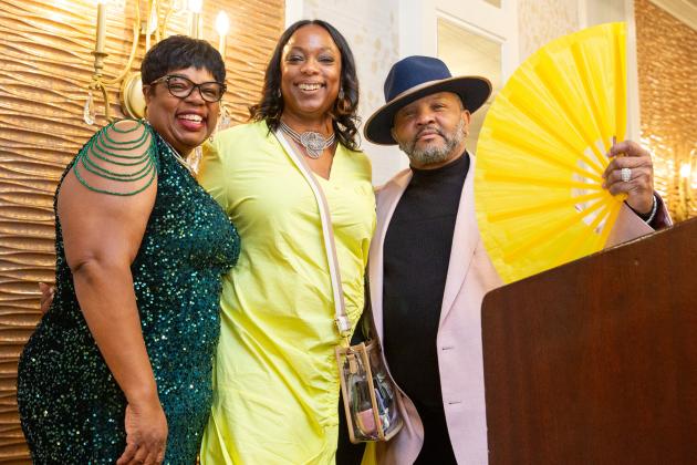 The hosts and emcee for the 2025 UFT African Heritage Committee Awards Dinner take a photo on stage. 