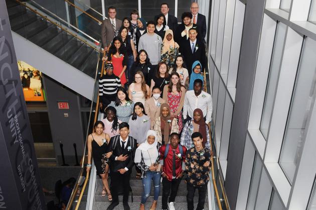 Large group poses on a staircase