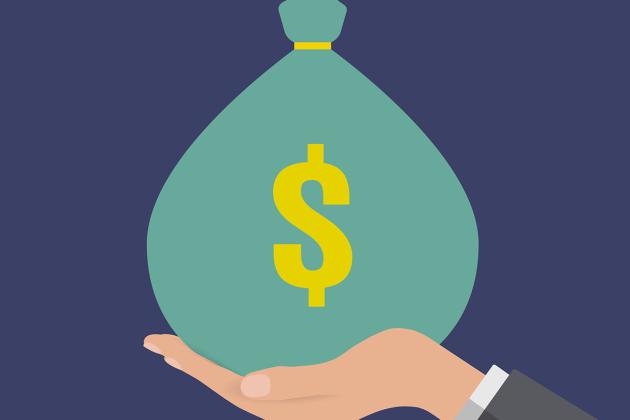 Green bag of money being held in palm of hand