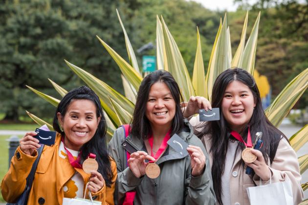 New UFT members show off their prizes won from the new member scavenger hunt held at the New York Botanical Garden on May 29, 2025. 